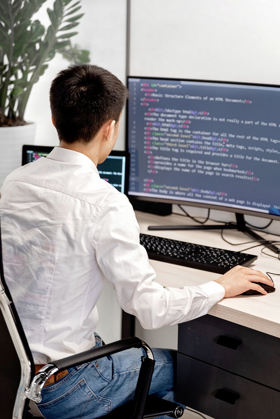 An engineer reading through source on a second monitor